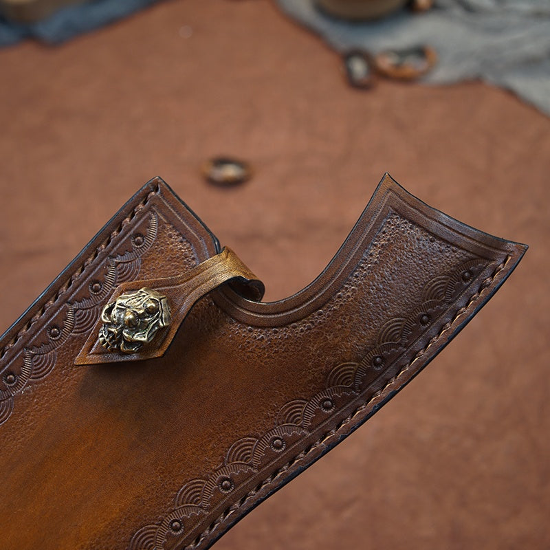Close up of the handmade leather sheath with copper skull seal 