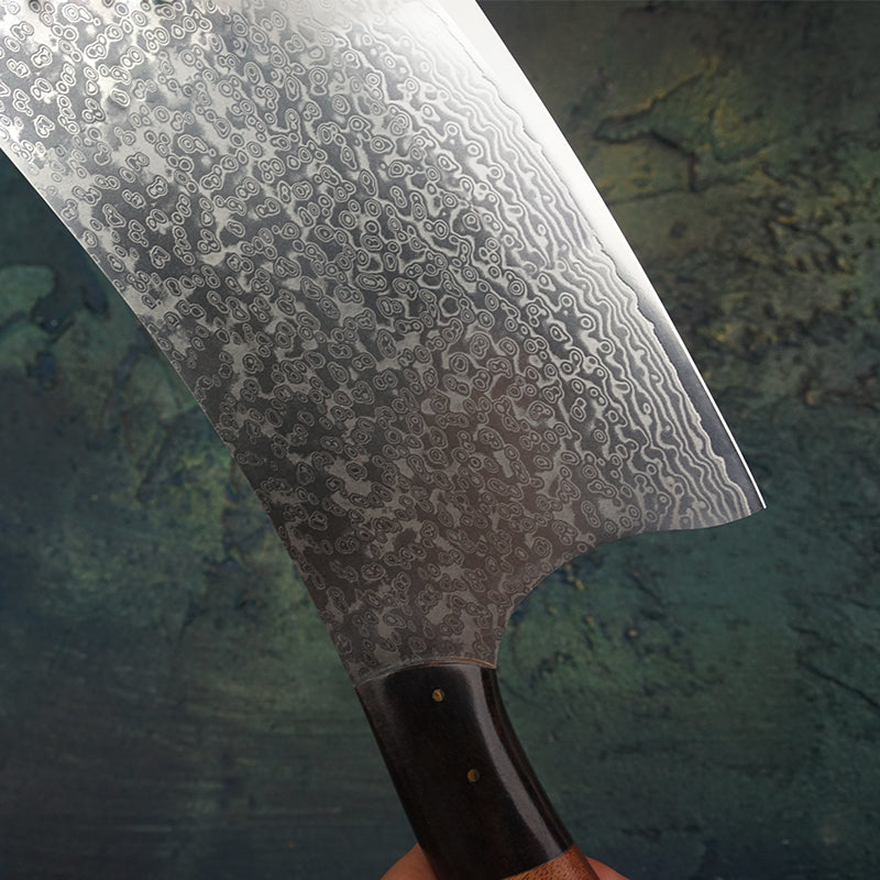 Close up of the blade showing the Damascus steel patters on the Chinese Butchers Cleaver made with VG10 Japanese steel with a red acid wood handle
